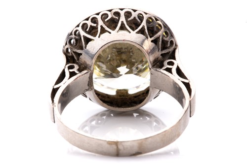 Lot 227 - A diamond solitaire ring, featuring a light...