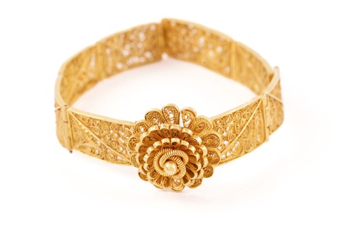 Lot 103 - A yellow metal filigree bracelet, set with...