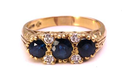 Lot 100 - A sapphire and diamond half hoop ring in 18ct...