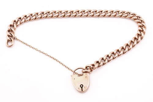 Lot 223 - A rose gold curb pattern bracelet; with...