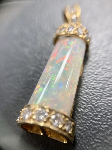 Lot 69 - An opal and diamond pendant, the tapering...