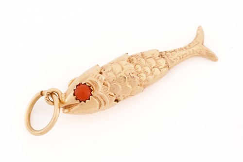 Lot 230 - A yellow metal articulated fish pendant with...