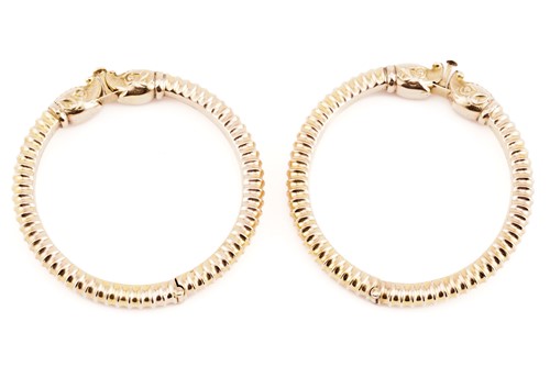 Lot 90 - A pair of Indian yellow metal hinged bangles,...