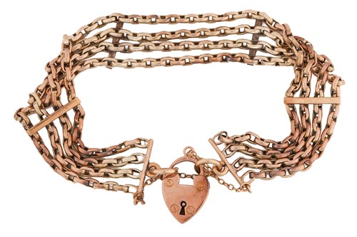 Lot 76 - A four-row bracelet with heart padlock,...