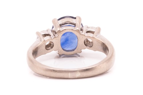 Lot 177 - A three-stone sapphire and diamond ring in...