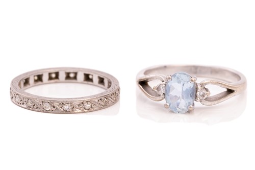 Lot 214 - A diamond eternity ring and a topaz trilogy...