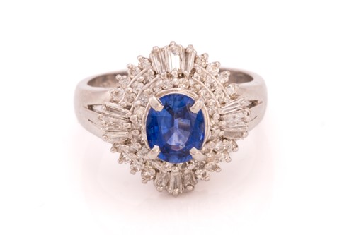 Lot 39 - A sapphire and diamond cluster ring, featuring...