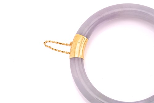 Lot 53 - A green and lavender jadeite hinged bangle,...