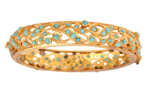 Lot 109 - A turquoise hinged bangle, of foliate design,...
