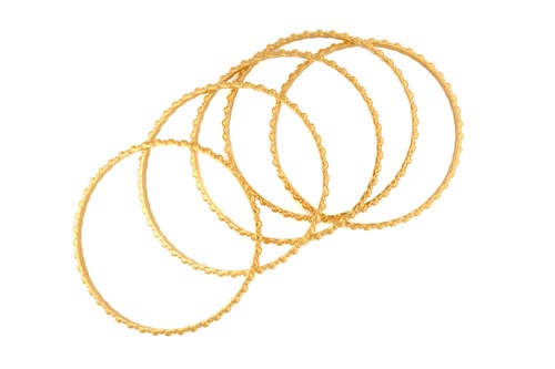 Lot 143 - A suite of five yellow metal bangles, of...