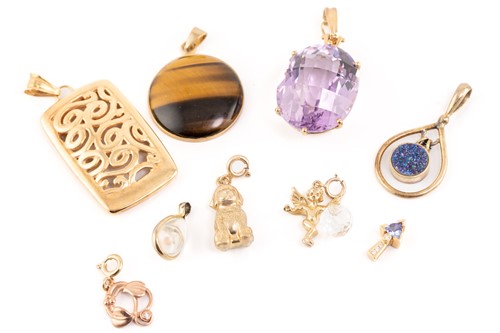 Lot 246 - A collection of nine pendants comprising a...