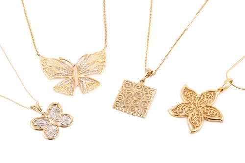 Lot 2 - A collection of four pieced-out pendants on...