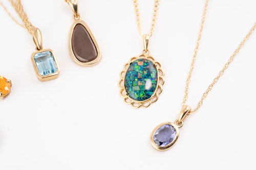 Lot 170 - A group of seven gem-set pendants on chain;...