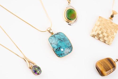 Lot 155 - A group lot consisting of six gem-set pendants...