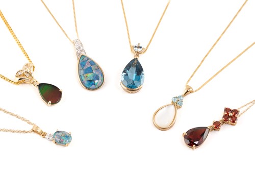 Lot 49 - Six gem-set drop pendants on chains; including...