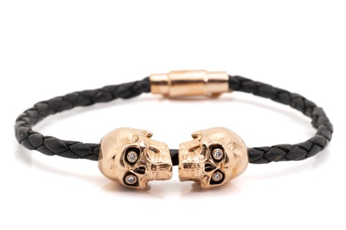 Lot 288 - A leather bracelet with diamond-set skull...