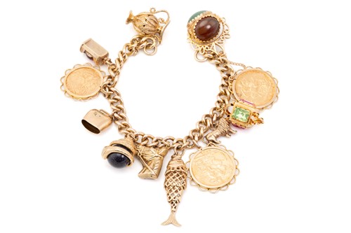 Lot 32 - A charm bracelet, the curb link bracelet...