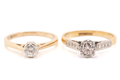 Lot 69 - Two single-stone diamond rings, featuring a...
