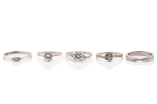 Lot 243 - A 9ct white gold and diamond two row crossover...