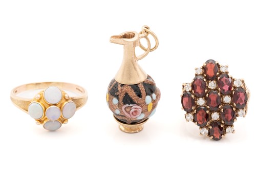 Lot 62 - Two 9ct gold gem-set rings and a jug charm;...