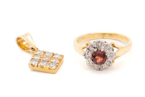 Lot 150 - An 18ct yellow gold, garnet, and diamond...