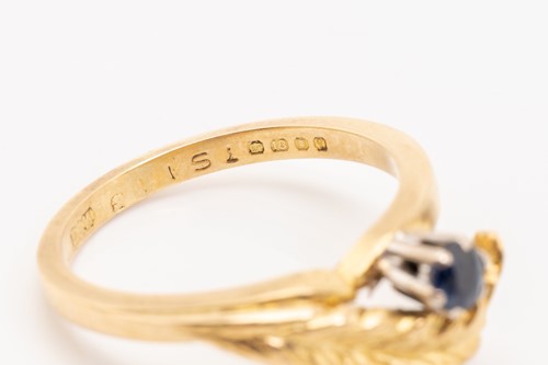 Lot 130 - An 18ct yellow gold bypass ring with leaf...