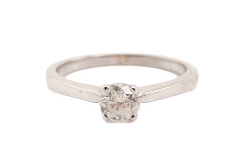 Lot 318 - A diamond solitaire ring in 18ct white gold,...