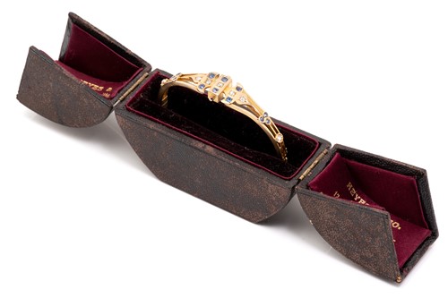 Lot 20 - A late Victorian gem-set hinged bangle, of...