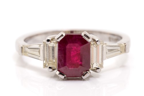 Lot 294 - A ruby and diamond trilogy ring, claw-set with...