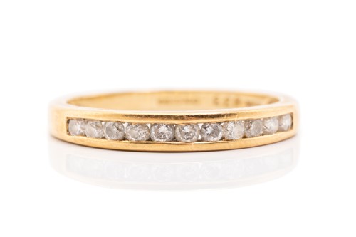 Lot 269 - An 18ct diamond half-eternity ring channel set...