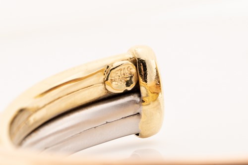 Lot 91 - A tri-coloured torque bracelet consisting of...