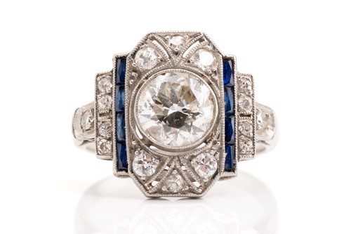 Lot 20 - An Art Deco diamond sapphire panel ring,...