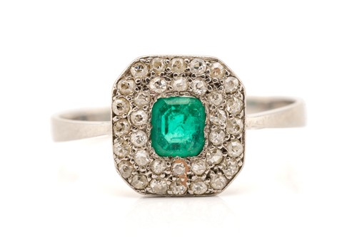 Lot 51 - An emerald and diamond cluster ring in...