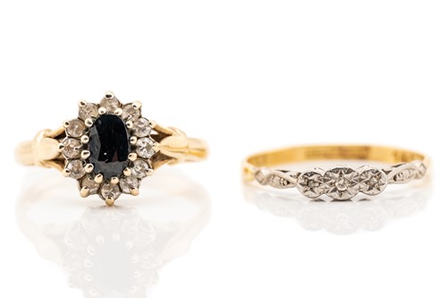 Lot 39 - A sapphire cluster ring, the oval cut sapphire...