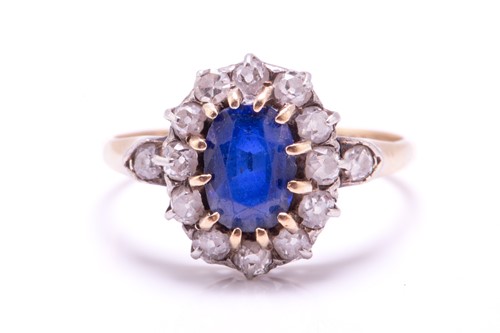 Lot 256 - A sapphire and diamond cluster ring; the oval...
