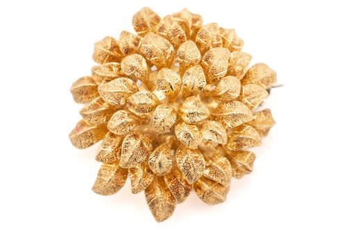 Lot 35 - An 18 carat gold flower head brooch; bombé...