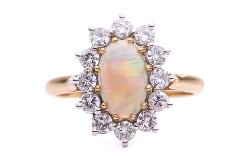 Lot 38 - An opal and diamond entourage ring in 18ct...