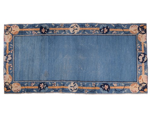 Lot 262 - A Chinese Peking blue ground rug, late Qing,...