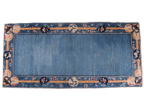 Lot 264 - A Chinese Peking blue ground rug, late Qing,...