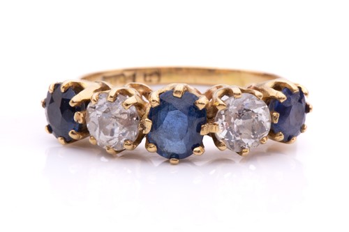 Lot 23 - A five-stone diamond and sapphire half-hoop...