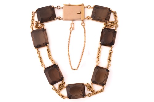 Lot 43 - A smokey quartz bracelet, the seven...