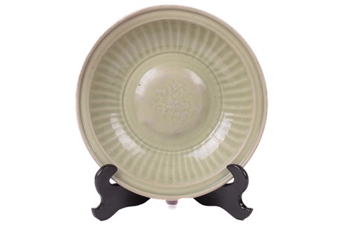 Lot 132 - A Chinese Longquan celadon charger with relief...