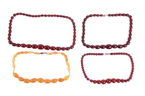 Lot 37 - A single-strand graduated amber bead necklace,...
