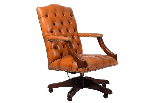 Lot 198 - A deep buttoned tan hide upholstered...