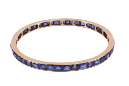 Lot 140 - A French sapphire-set closed bangle,...