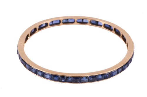 Lot 140 - A French sapphire-set closed bangle,...