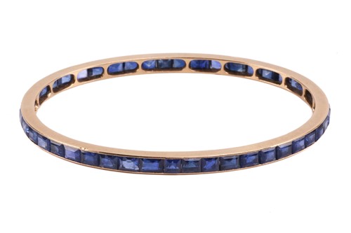 Lot 140 - A French sapphire-set closed bangle,...