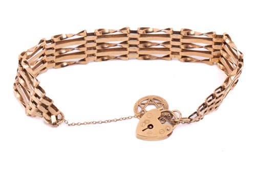 Lot 7 - A five-row gate link bracelet with charm in...