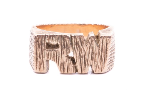 Lot 69 - An initial ring with bark finish, presenting...