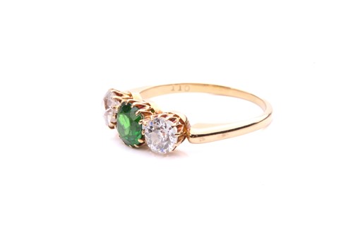 Lot 26 - A tsavorite and diamond three-stone ring,...
